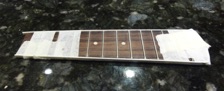 After the fretboard is fretted, the binding can be glued onto the edges.